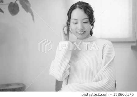 A daughter prays for her deceased loved one at home (black and white) A daughter prays for her deceased loved one at home (black and white) 138603176