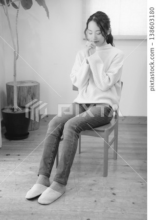 A daughter prays for her deceased loved one at home (black and white) A daughter prays for her deceased loved one at home (black and white) 138603180