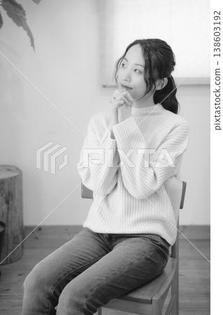 A daughter prays for her deceased loved one at home (black and white) A daughter prays for her deceased loved one at home (black and white) 138603192