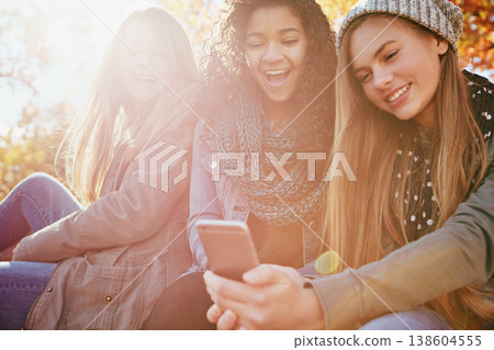 Phone, meme or funny friends in park with smile for holiday vacation on social media post for gossip news. Happy people, drama or gen z girls in nature talking, speaking or laughing at comedy joke Phone, meme or funny friends in park with smile for holiday vacation on social media post for gossip news. Happy people, drama or gen z girls in nature talking, speaking or laughing at comedy joke 138604555