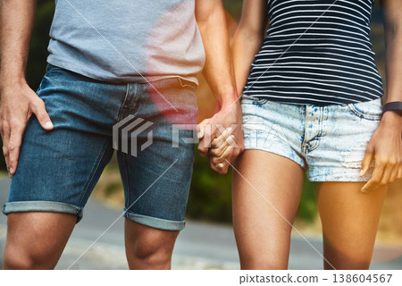 Closeup, love or couple holding hands on date with support, respect or care for romance on road. Walking, bokeh zoom or man by woman on holiday vacation together for bond, loyalty or relax in street 138604567