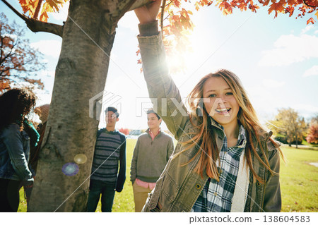 Happy teen girl in nature with friends, park and autumn, sunshine with wellness and portrait. Youth relax outdoor, enjoy fresh air and bonding with smile, lens flare with adventure or travel Happy teen girl in nature with friends, park and autumn, sunshine with wellness and portrait. Youth relax outdoor, enjoy fresh air and bonding with smile, lens flare with adventure or travel 138604583