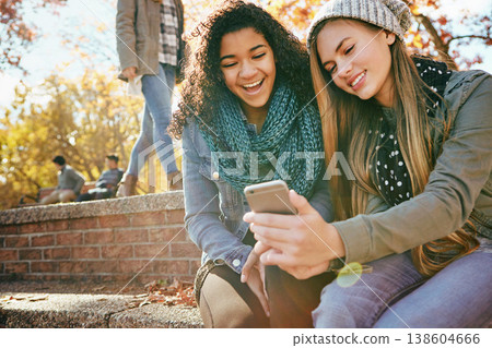 Phone, students or friends online in park with smile together for holiday vacation outdoors on social media. Happy people, gossip or gen z girls in nature talking, speaking or laughing at comedy joke Phone, students or friends online in park with smile together for holiday vacation outdoors on social media. Happy people, gossip or gen z girls in nature talking, speaking or laughing at comedy joke 138604666