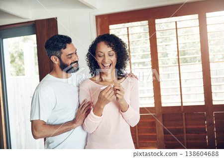 Couple, excited and positive pregnancy test at home, hug and happy for future, support and love. Smiling people, success and pregnant by ivf, fertility and good news, results and celebration for baby Couple, excited and positive pregnancy test at home, hug and happy for future, support and love. Smiling people, success and pregnant by ivf, fertility and good news, results and celebration for baby 138604688