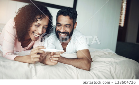 Couple, happy and bedroom with pregnancy test, positive and bed with smile, results and excited. Man, woman and baby with stick, love and maternity for future family, surprise and pregnant together Couple, happy and bedroom with pregnancy test, positive and bed with smile, results and excited. Man, woman and baby with stick, love and maternity for future family, surprise and pregnant together 138604726
