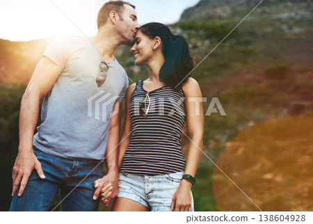 Mountain, kiss or happy couple holding hands on date with wellness or care for romance or adventure. Bokeh, smile or man with woman on holiday vacation together for bond or support in nature or park 138604928
