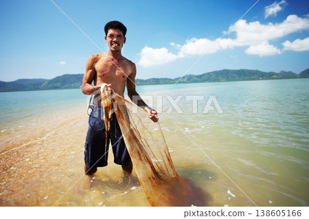 Fisherman, ocean and man with net working, nature and labor with fishing in Thailand and tropical island. Sea, job and rope with worker in water to catch fish and beach with environment and portrait Fisherman, ocean and man with net working, nature and labor with fishing in Thailand and tropical island. Sea, job and rope with worker in water to catch fish and beach with environment and portrait 138605166