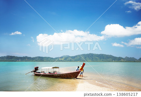 Boat, transport and travel, beach and ocean with people and paradise, tropical island with nature and vacation. Holiday in Thailand with transportation, sea vessel for fishing and outdoor adventure 138605217