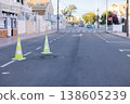 Yellow green cones with a white stripe on the asphalt road. Drive safety and constructions concept. 138605239