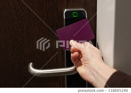 Hand holding key card near electronic door lock Hand holding key card near electronic door lock 138605240