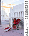 Fire hydrant in a street. Opened red fire hydrant on the street. Closeup. 138605245
