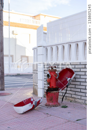 Fire hydrant in a street. Opened red fire hydrant on the street. Closeup. Fire hydrant in a street. Opened red fire hydrant on the street. Closeup. 138605245