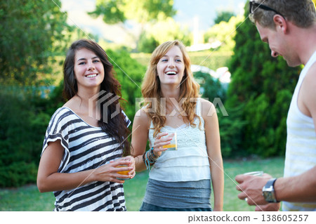 Happy, friends and drinks in backyard of home with juice, laughing and conversation in garden. BBQ, young people with talking group with smile outdoor with discussion and funny joke ready for summer 138605257