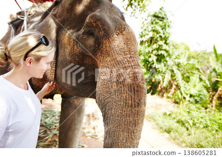 Travel, conservation and woman with elephant in a jungle for adventure, freedom and experience. Nature, wildlife and female tourist in Thailand bonding with animal in forest with environment and fun 138605281