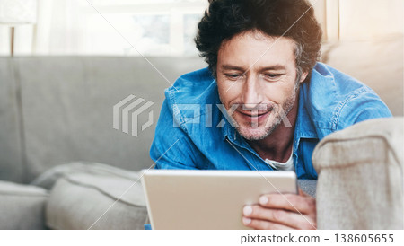 Man, relax and tablet internet on couch for digital contact, social media or movie app. Male person, streaming film and online shop connection or connectivity fun for comfort, weekend joy on sofa Man, relax and tablet internet on couch for digital contact, social media or movie app. Male person, streaming film and online shop connection or connectivity fun for comfort, weekend joy on sofa 138605655