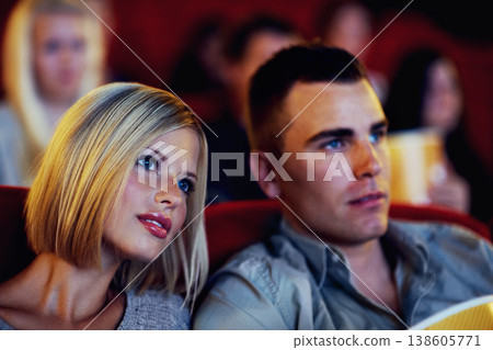 Cinema, movie and couple watching film, entertainment and popcorn on romantic evening together. Date night, man and woman in Hollywood theater with snacks, show and sitting in auditorium to relax. 138605771