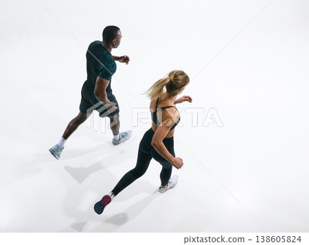 Fit couple running performing cardio training exercise in studio. Fit couple running performing cardio training exercise in studio. 138605824