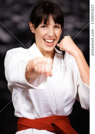 Woman, karate and punch in portrait, fight and self defense sport with muay thai and training. Athlete, combat and power with fitness, martial arts and energy with warrior, exercise and taekwondo 138605825