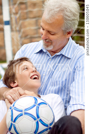 Senior, man or boy with smile and ball for football, sport or bonding in backyard, garden or field. Family, elderly person or son with happiness for soccer match, game or performance at home for care Senior, man or boy with smile and ball for football, sport or bonding in backyard, garden or field. Family, elderly person or son with happiness for soccer match, game or performance at home for care 138605845