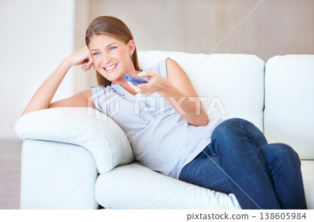 Woman, remote control and watching tv on couch, happy at home with entertainment and streaming with internet. Subscription, change the channel with network and movie, film or show choice with smile Woman, remote control and watching tv on couch, happy at home with entertainment and streaming with internet. Subscription, change the channel with network and movie, film or show choice with smile 138605984