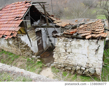 Abandoned, house and outdoor with war, ruins and destruction of countryside property from bomb. Warzone, building or broken roof damage on home or cottage shed in rural, farm or woods in nature Abandoned, house and outdoor with war, ruins and destruction of countryside property from bomb. Warzone, building or broken roof damage on home or cottage shed in rural, farm or woods in nature 138606077