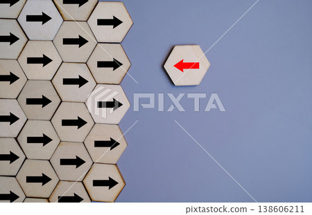 Leadership and uniqueness represented by a red arrow moving against the crowd of black arrows Leadership and uniqueness represented by a red arrow moving against the crowd of black arrows 138606211