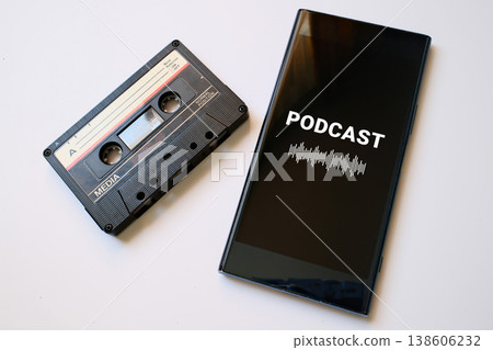 Vintage audio casette and mobile phone with podcast app on screen 138606232