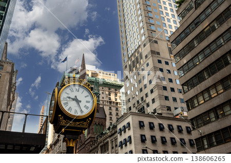 New york, usa august 14,2024. Large ornate street clock with roman numerals, reading trump tower, against a backdrop of modern and historic buildings under a blue sky New york, usa august 14,2024. Large ornate street clock with roman numerals, reading trump tower, against a backdrop of modern and historic buildings under a blue sky 138606265