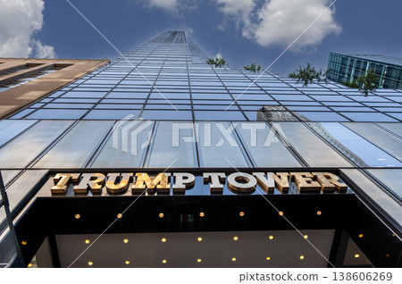 New york, usa august 14,2024. Trump tower skyscraper exterior showcasing its glass facade and golden sign, featuring reflections of the cityscape and clouds New york, usa august 14,2024. Trump tower skyscraper exterior showcasing its glass facade and golden sign, featuring reflections of the cityscape and clouds 138606269