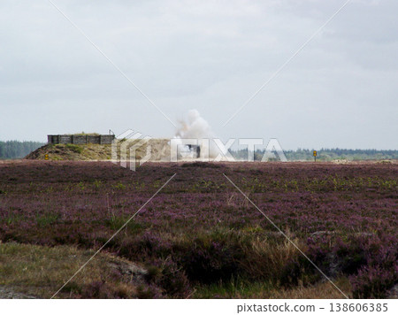 War, explosion and missile attack in the countryside during conflict or fighting for freedom with space. Sky, mockup and bomb with a cloud of smoke outdoor on a military warzone or battlefield 138606385