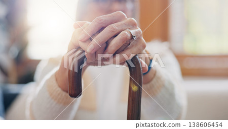 Walking stick, hands and senior woman with a disability in home, apartment or retirement with support for injury. Elderly, closeup or person with wood cane to help balance or mobility with arthritis Walking stick, hands and senior woman with a disability in home, apartment or retirement with support for injury. Elderly, closeup or person with wood cane to help balance or mobility with arthritis 138606454