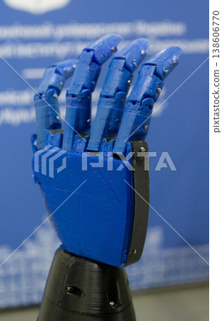 A functional 3D-printed robotic prosthetic hand. Object printed on 3D printer from melted plastic. Model palm with fingers created on 3D printer from threads of molten plastic. Medicine technologies 138606770