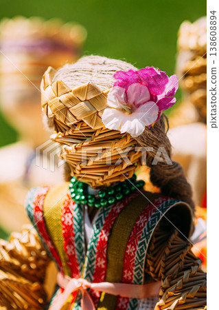 Colorful Belarusian Straw Dolls At The Market In Belarus. Faceless handmade woven straw doll with colorful clothes and flower. Colorful Belarusian Straw Dolls At The Market In Belarus. Faceless handmade woven straw doll with colorful clothes and flower. 138608894