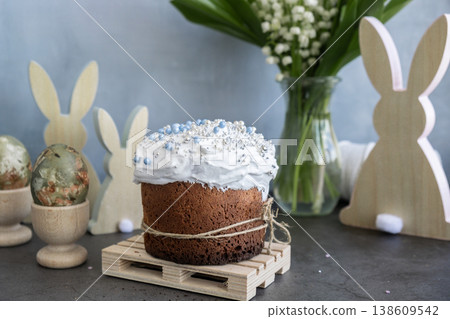 Sweet homemade Easter cake panettone with meringue and creative decoration food. Preparation for Christian holiday Kulich. Easter eggs and bunny Sweet homemade Easter cake panettone with meringue and creative decoration food. Preparation for Christian holiday Kulich. Easter eggs and bunny 138609542