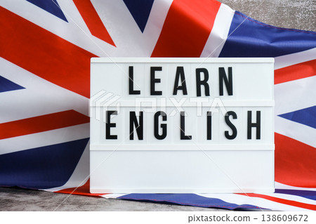 Message LEARN ENGLISH on background of Great Britain UK flag made from silk. British national flag with concept of tourism and traveling students opportunities scholarship programs Message LEARN ENGLISH on background of Great Britain UK flag made from silk. British national flag with concept of tourism and traveling students opportunities scholarship programs 138609672