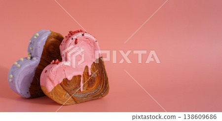 Delicious fresh croissant topped with colorful flavor Ganache. Creation unique heart shape bakery. Puff pastry holiday love gift present idea Valentine's day Delicious fresh croissant topped with colorful flavor Ganache. Creation unique heart shape bakery. Puff pastry holiday love gift present idea Valentine's day 138609686