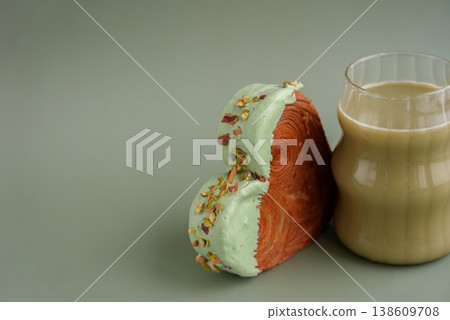 Green tea Matcha latte cappuccino beverage Morning breakfast gift idea Heart shaped pistachio croissant on green background with copy space. Puff pastry trendy sweet dessert bakery. Creamy dough 138609708