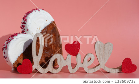 Wooden word love decoration Delicious fresh croissant topped with colorful flavor Ganache. Creation unique heart shape bakery. Puff pastry holiday love gift present idea Valentine's day 138609732