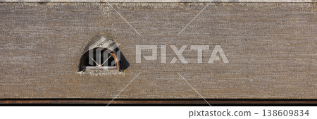 Background texture of a thatched roof showcasing an arched dormer window 138609834