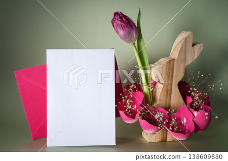 Easter mock up envelope empty card template Creative vibrant handmade Easter table decoration with egg shells wooden bunny on pastel green background copy space. Greeting card idea Easter home 138609880