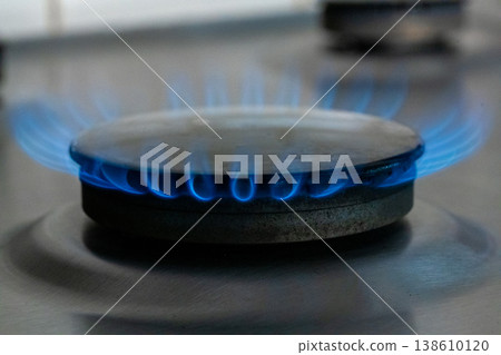 Natural Gas. High prices of natural gas. Blue flames of gas burning from a kitchen gas stove burner Natural Gas. High prices of natural gas. Blue flames of gas burning from a kitchen gas stove burner 138610120