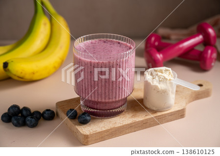 Banana blueberry protein smoothie in a glass. Banana blueberry protein smoothie in a glass. 138610125