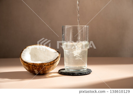Pouring fresh coconut water in a glass 138610129