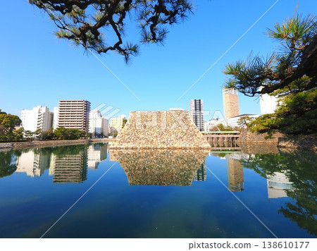 Tamamo Park's stone walls, pond, and cityscape reflected in the sky. Takamatsu City, Kagawa Prefecture. 2 Tamamo Park's stone walls, pond, and cityscape reflected in the sky. Takamatsu City, Kagawa Prefecture. 2 138610177