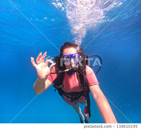 Woman scuba diving showing ok sign underwater selfie Woman scuba diving showing ok sign underwater selfie 138610195