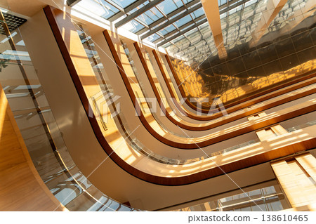 Modern atrium interior with curved balconies Modern atrium interior with curved balconies 138610465