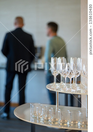 Empty wine glasses and tumblers arranged on a two-tiered stand Empty wine glasses and tumblers arranged on a two-tiered stand 138610480