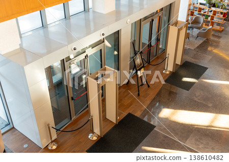 Modern building entrance with security metal detectors 138610482