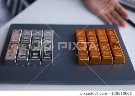 Businessman investing in precious metals gold and silver to diversify portfolios hedge against inflation and currency depreciation. Businessman investing in precious metals gold and silver to diversify portfolios hedge against inflation and currency depreciation. 138610668
