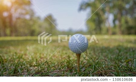 Golf balls on a green lawn in a beautiful golf course with morning sunshine. Golf balls on a green lawn in a beautiful golf course with morning sunshine. 138610686